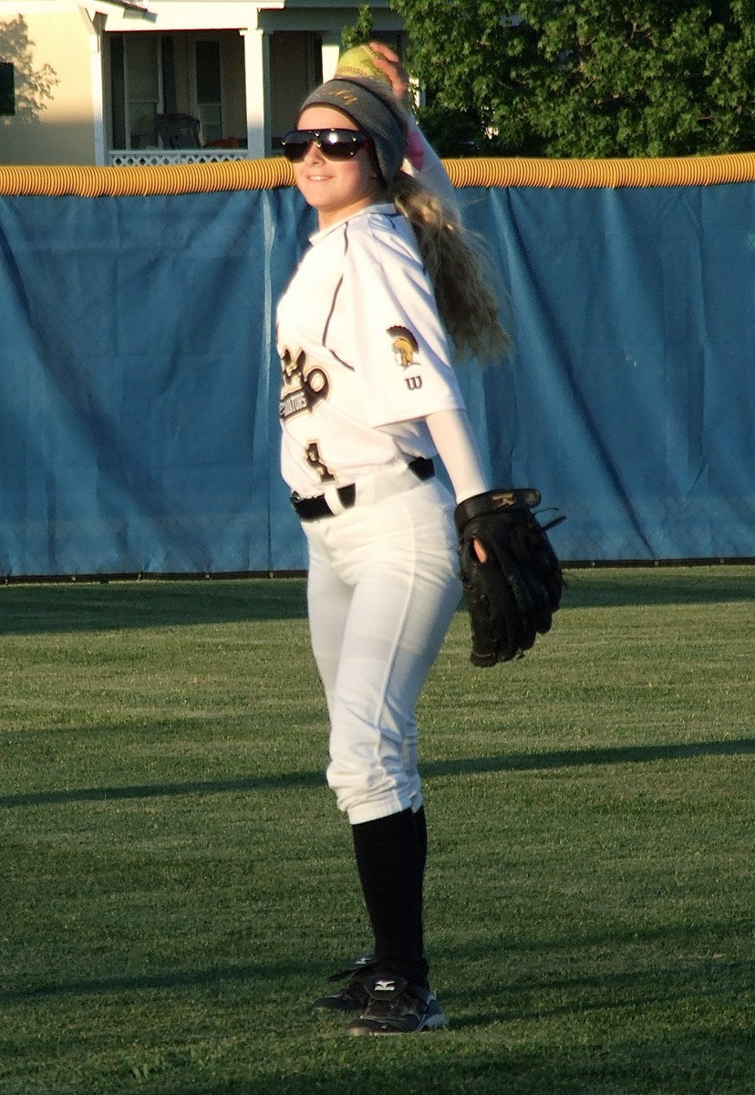 Image: Out fielder Britney Chambers(4) warms up as the second game gets underway.