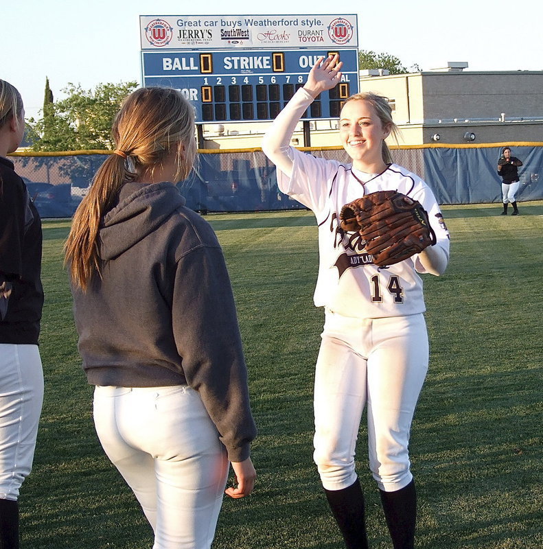 Image: Kelsey Nelson(14) rushes over to give high five to Hannah Washington(6) as the Lady Gladiators get pumped up for game two.