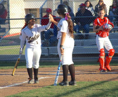 Image: Bailey Eubank(1) gets a high-five from teammate Alyssa Richards(9) after Eubank scores an Italy run. Eubank scored 3 runs in total over the course of both games with 1 single, 2 walks and knocked in 1 RBI as well.