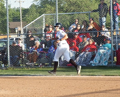 Image: Alyssa Richards(9) checks the path of her hit as she nears first base.