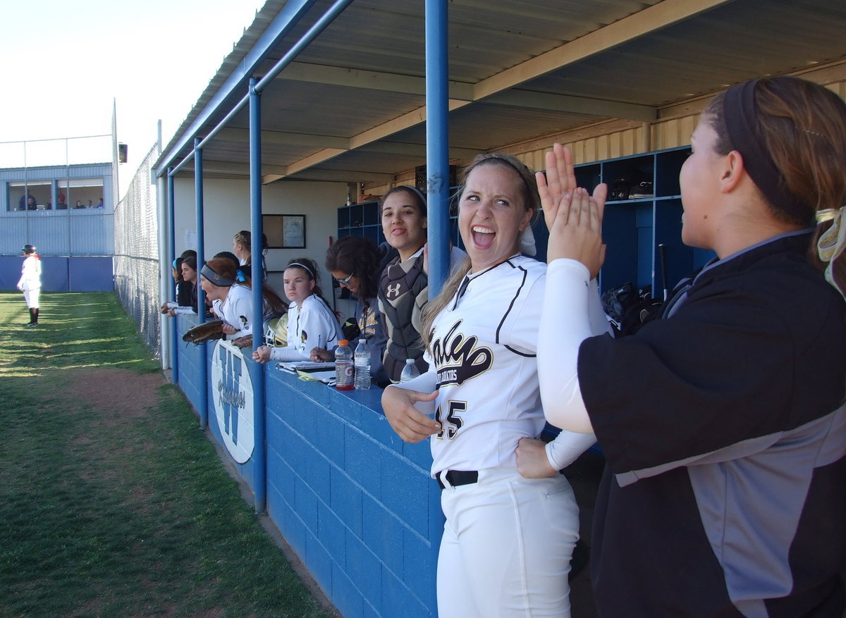 Image: Paige Westbrook(10), Jaclynn Lewis(15) and Alyssa Richards(9) help cheer on their fellow batters.