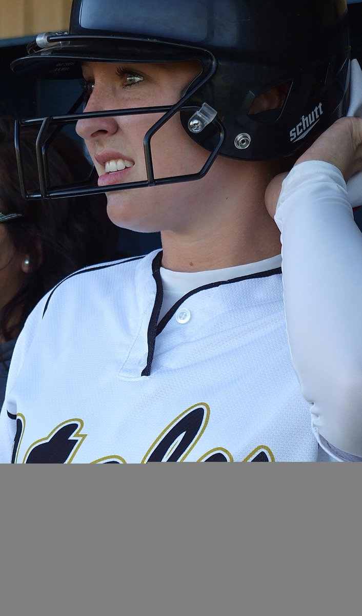 Image: Jaclynn Lewis(15) watches the field action from Italy’s dugout.