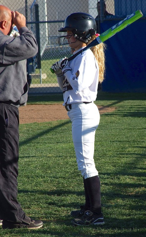 Image: Britney Chambers(4) gets some hitting advice from Lady Gladiator head coach Wayne Rowe before Chambers takes her turn at bat.