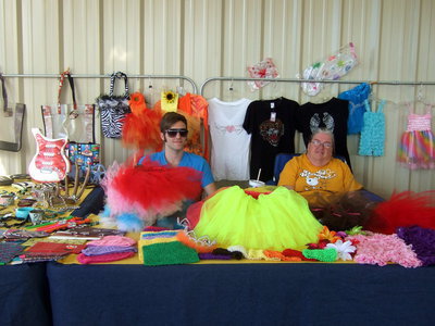 Image: Cody Beasley with their booth of children’s apparel, duct tape wallets and jewelry.