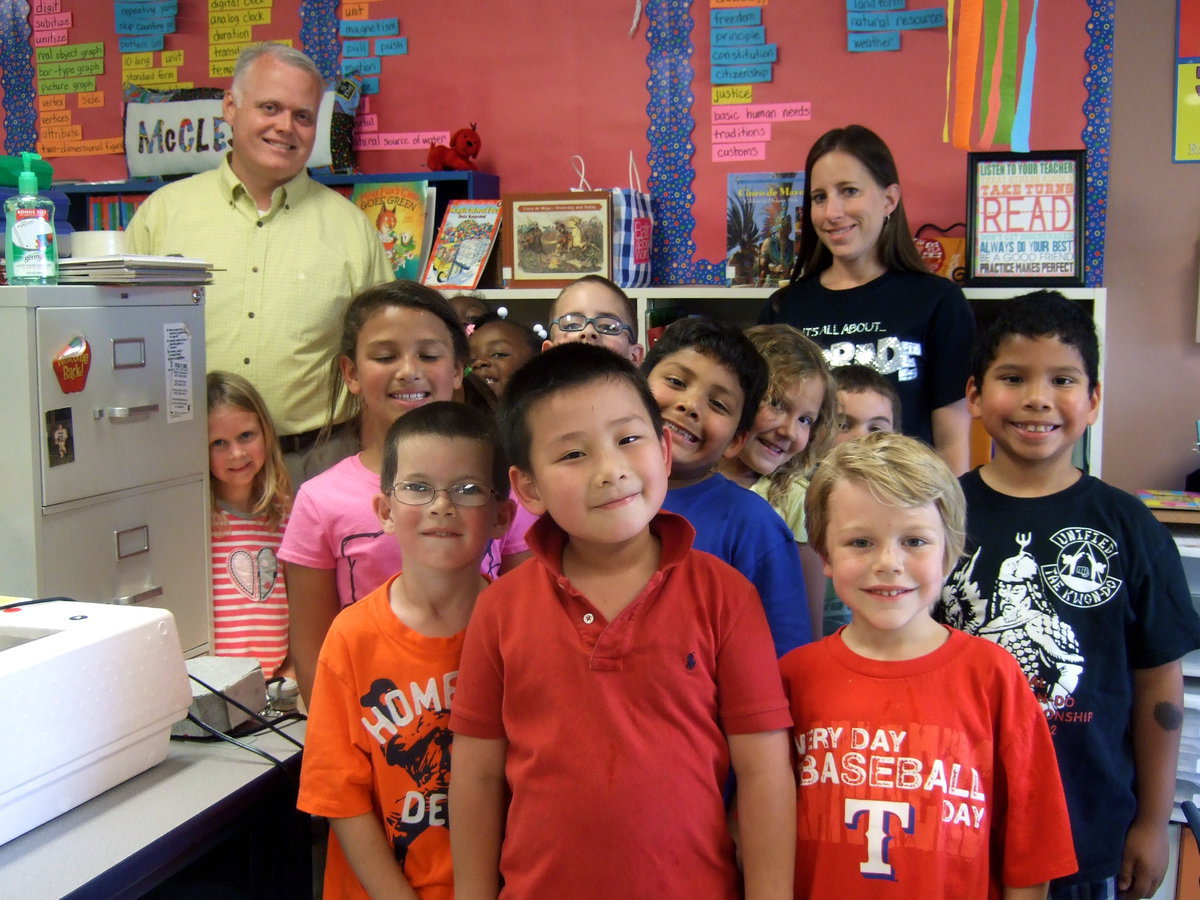 Image: First graders, Mr. Nash (principal) and Mrs. McClesky love learning about the chicks.