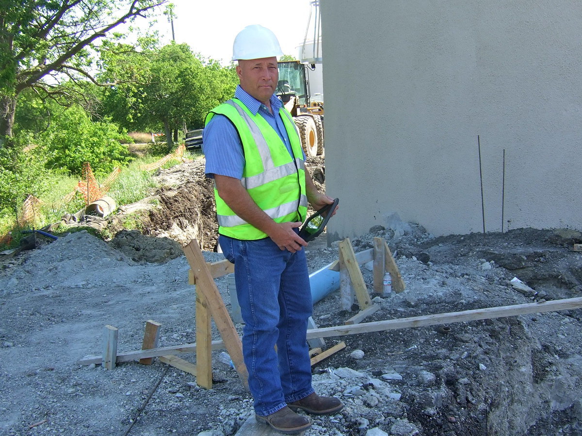 Image: Dean Carrell inspecting the progress around the tank.