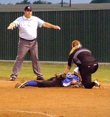 Image: A Lady Bulldog base runner dives back to first base under the tag of Italy first baseman Katie Byers(13).