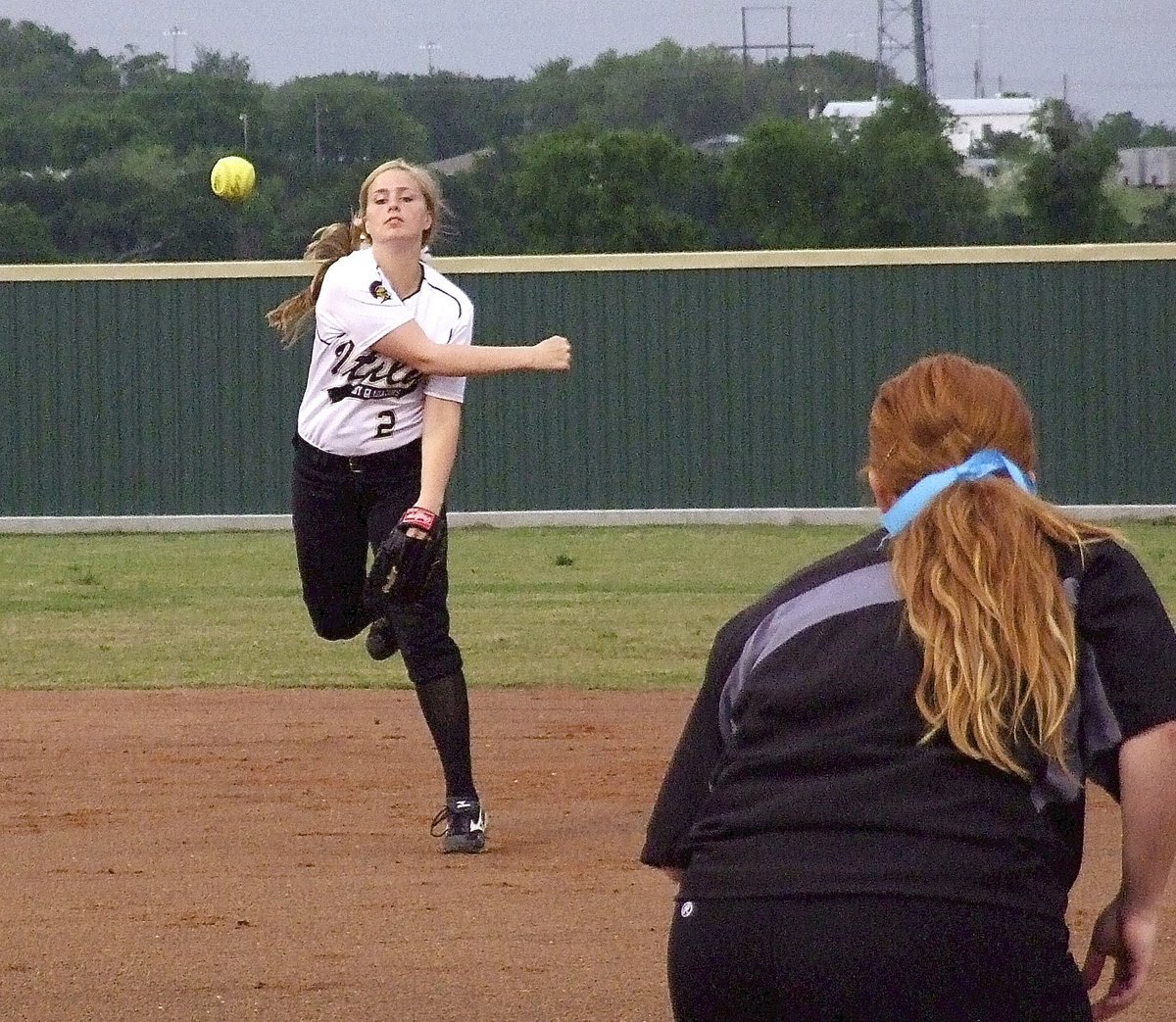 Image: Shortstop Madison Washington(2) throws to first baseman Katie Byers(13) for an Italy out.