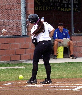 Image: Alyssa Richards(9) is tagged with a pitch and is not happy about it as she walks slowly to first base.