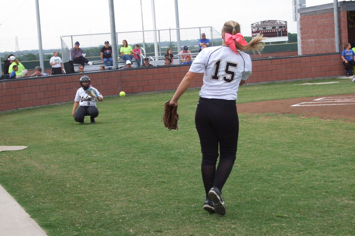 Image: Lady Gladiator Jaclynn Lewis(15) pitches to teammate Alyssa Richards(9) before the game between Italy and Bosqueville.