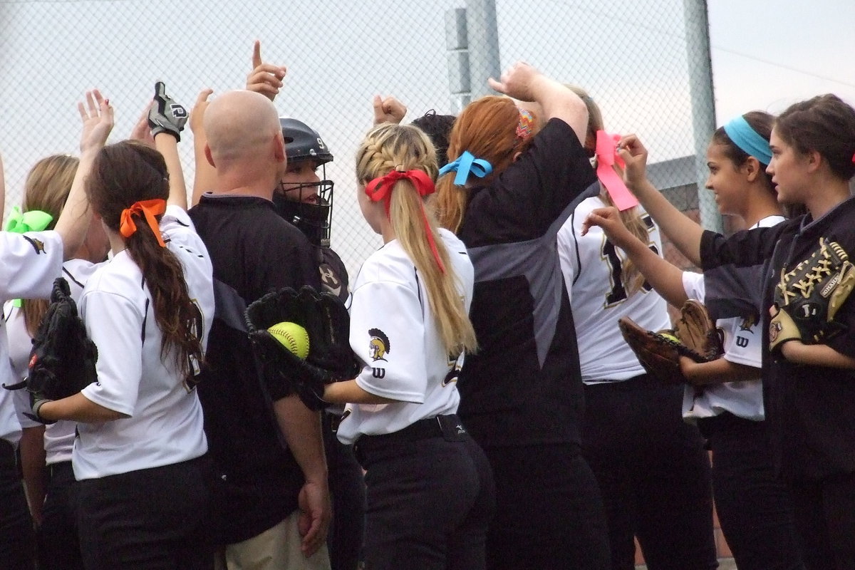 Image: Senior Alyssa Richards(9) helps fire her teammates up before taking the field.