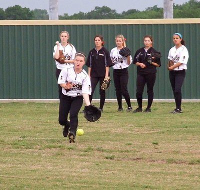 Image: Tara Wallis(5) and her outfield mates get warmed up before the game against Bosqueville.