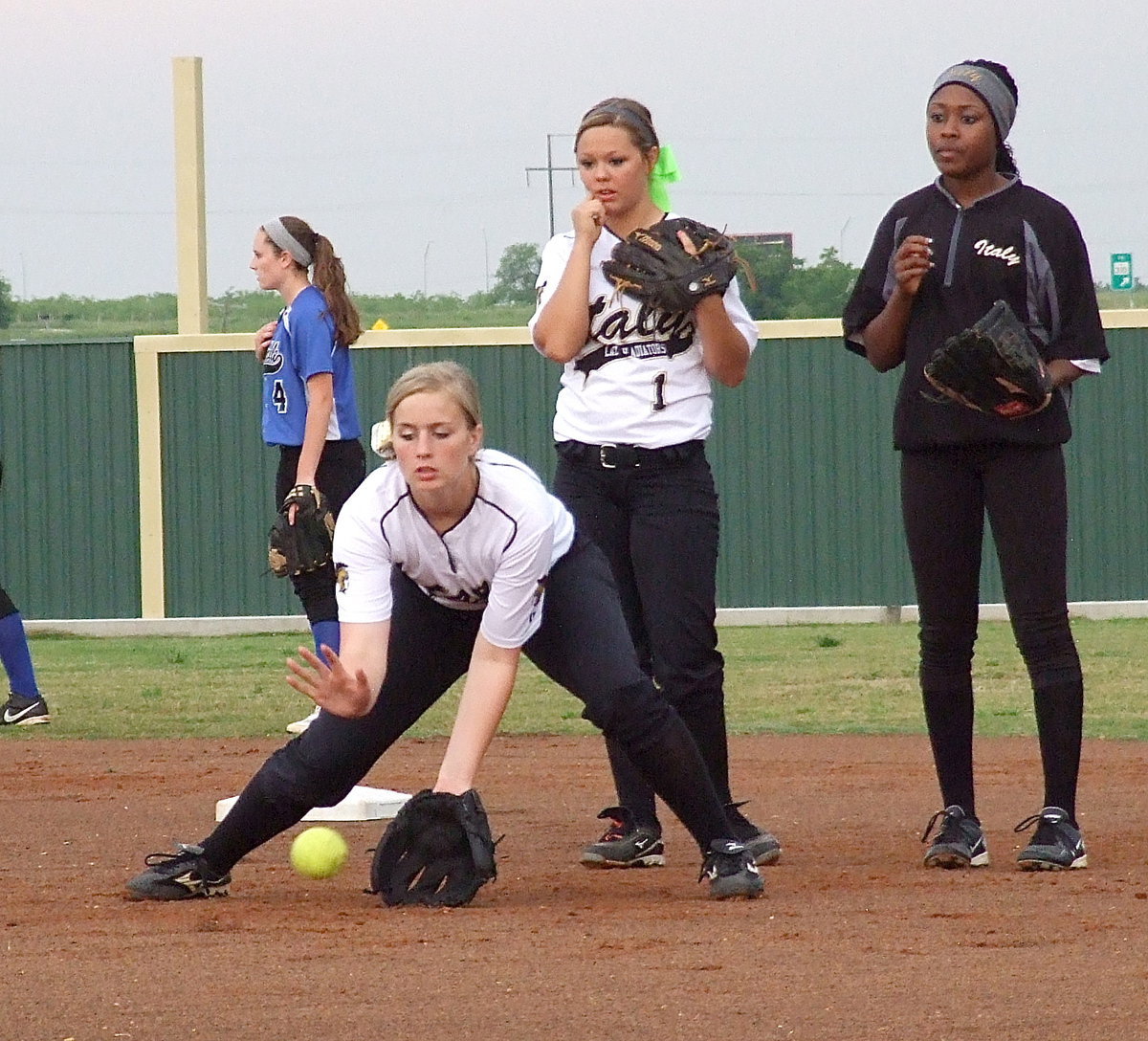 Image: Madison Washington(2) fields a practice grounder before the game.