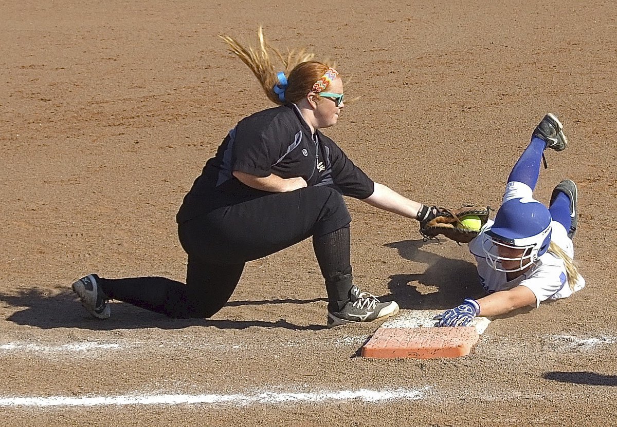 Image: Lady Gladiator senior first baseman Katie Byers(13) attempts to tag out a Bosqueville runner who dives back to the bag.