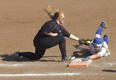 Image: Lady Gladiator senior first baseman Katie Byers(13) attempts to tag out a Bosqueville runner who dives back to the bag.