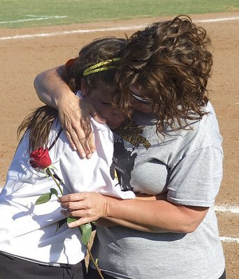 Image: Senior right fielder Morgan Cockerham(8) finds the strength to present her mom Dustie Jones with a Mother’s Day rose after Italy’s heartbreaking game one and game two losses to Bosqueville on Saturday.