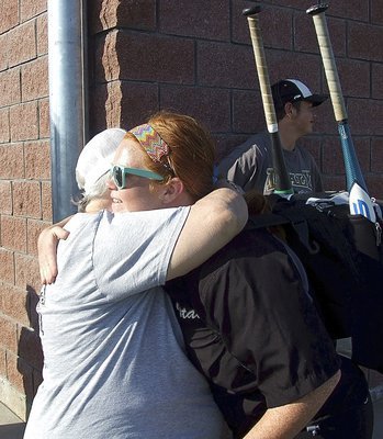 Image: Senior Katie Byers(13) receives a hug from her grandmother Ann Byers after Katie’s final game as a Lady Gladiator softball player.