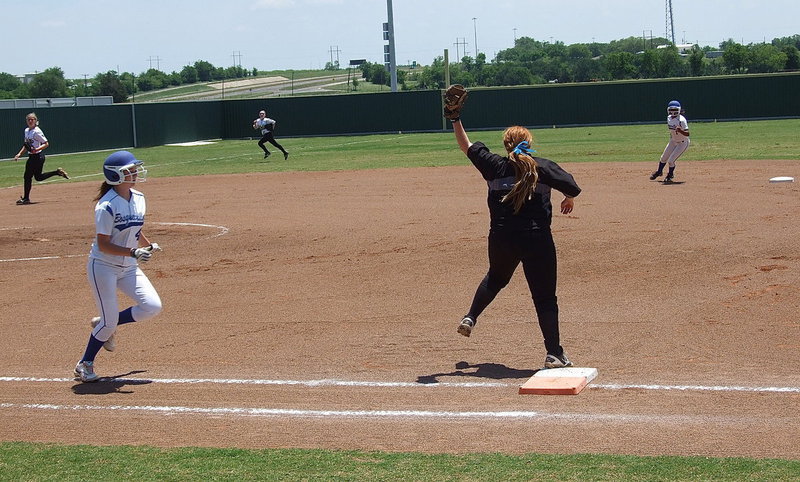 Image: First baseman Katie Byers(13) makes the grab on a slightly high throw to first base catching Bosqueville way short of the bag for an out.