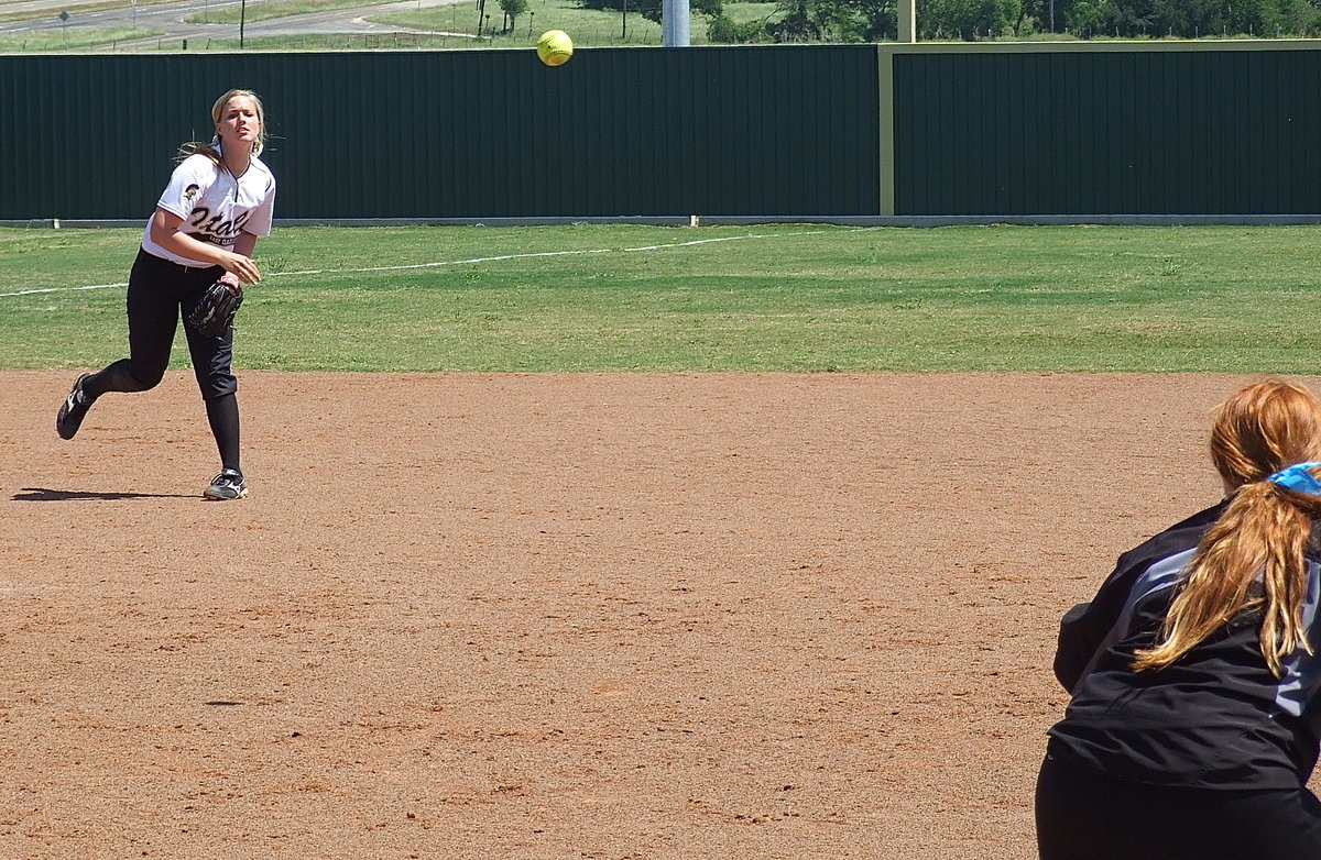 Image: Madison Washington(2) throws out a Bosqueville runner at first base with Katie Byers covering the bag.