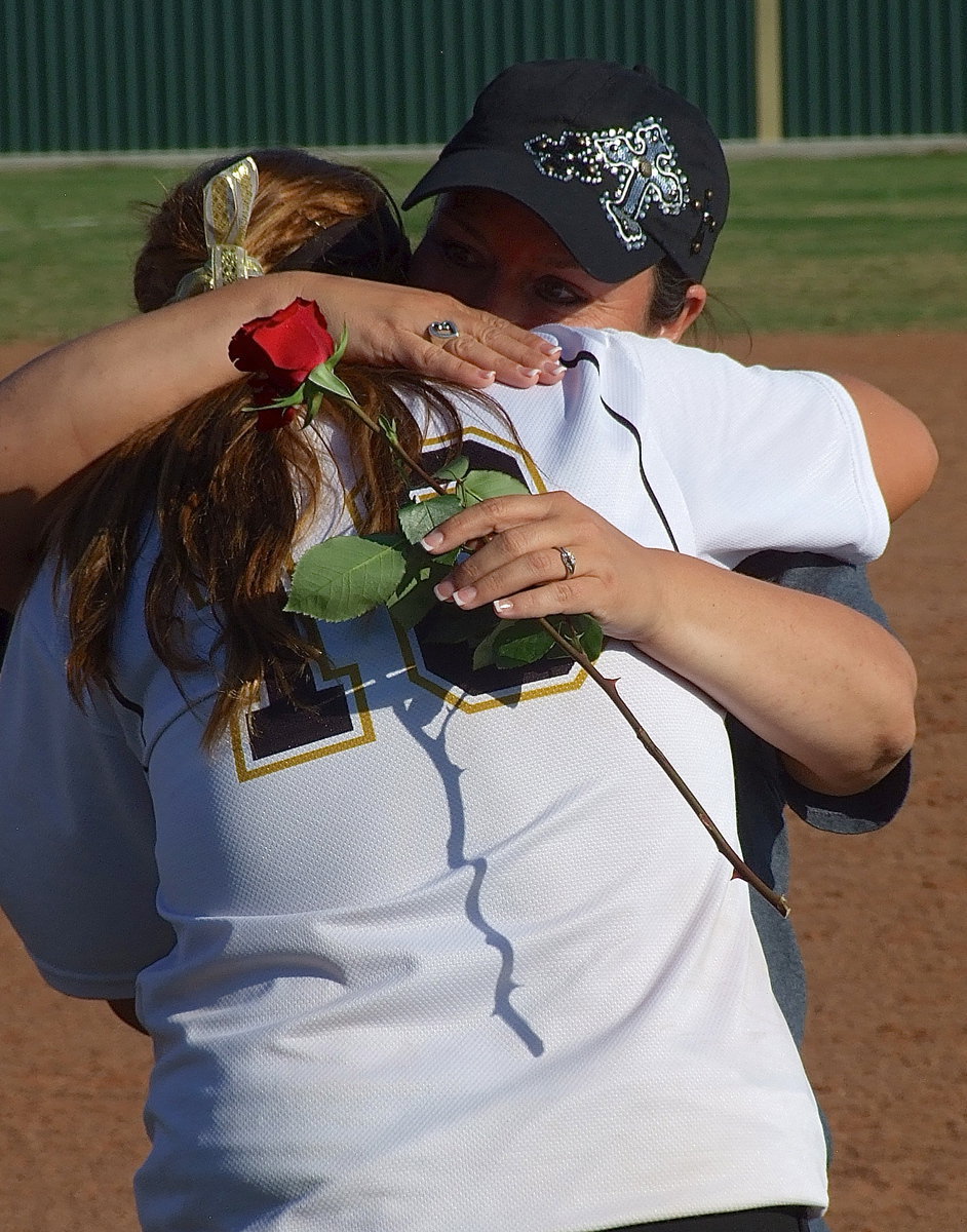 Image: Italy junior Paige Westbrook presents her mother Angie with a rose for Mother’s Day as the two share a bittersweet moment following the Lady Gladiators’ exit from the playoffs at the paws of the Lady Bulldogs from Bosqueville.