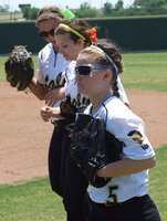 Image: Tara Wallis(5), Morgan Cockerham(8) and Bailey Eubank(1) hustle in for the start of game two of the series.