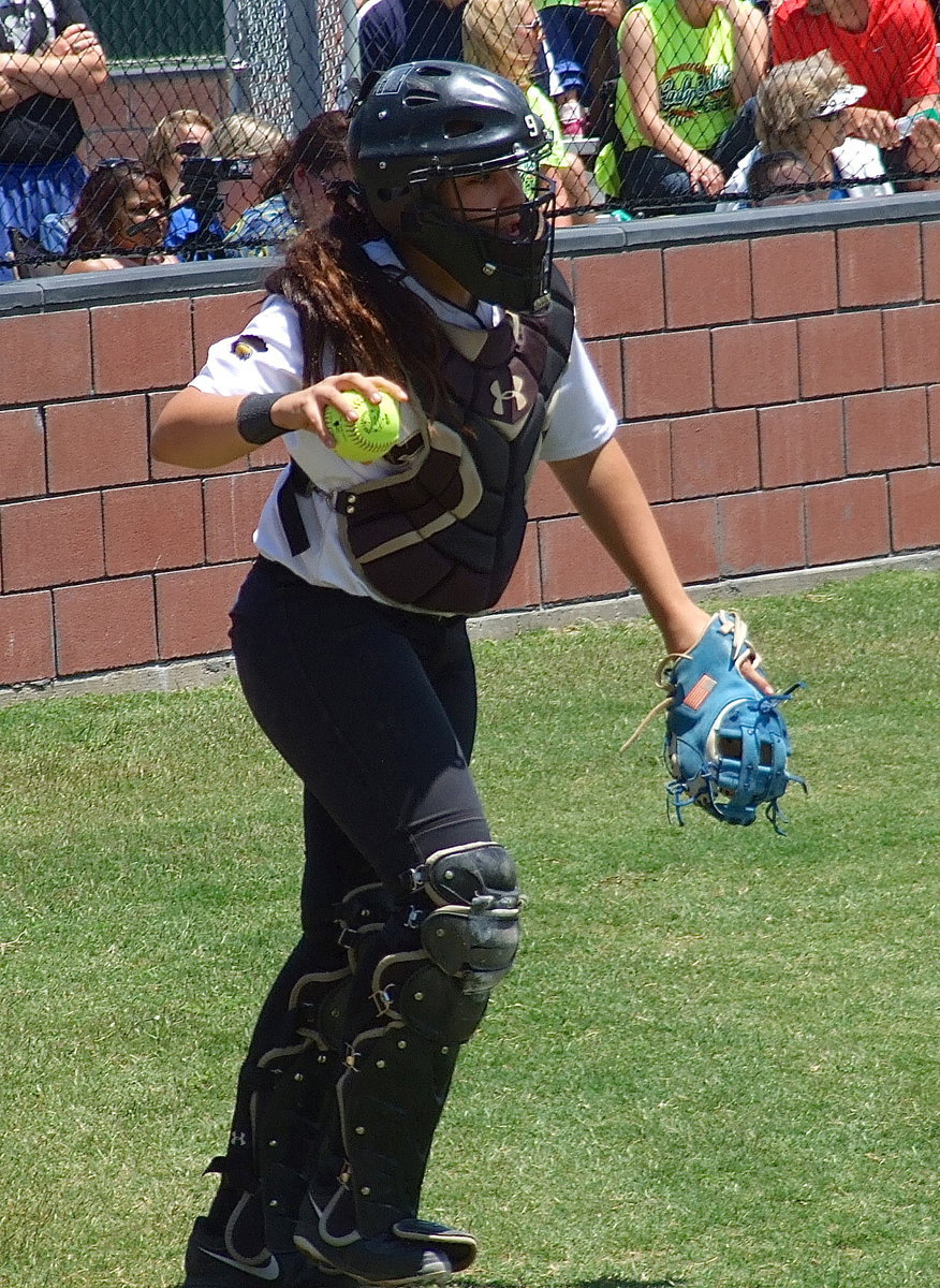 Image: Senior catcher Alyssa Richards(9) retrieves a foul ball during Italy’s playoff battle with Bosqueville.