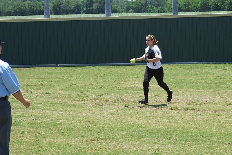 Image: Lady Gladiator right fielder Morgan Cockerham(8), a senior, makes the catch for an out and then runs the ball in towards the infield to hold runners on base.