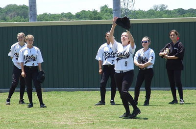 Image: Senior outfielder Morgan Cockerham(8) gets under a fly ball during warmups as teammates Kelsey Nelson(14), Britney Chambers(4), Ashlyn Jacinto(7), Tara Wallis(5) and Cassidy Childers(3) wait for their turn.