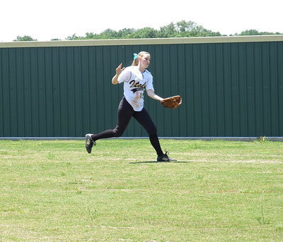 Image: Kelsey Nelson(14) displays the skills she has as a center fielder for Italy.