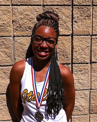Image: Ryisha Copeland, a junior, displays her regional medal earned from competing in the 4×100 Meter Relay as a State qualifying member of Italy High School’s 2013 1A track team.
