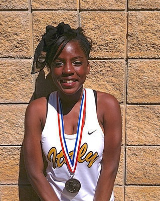Image: Kendra Copeland, a junior, displays her regional medal earned from competing in the 4×100 Meter Relay as State qualifying member of Italy High School’s 2013 1A track team.