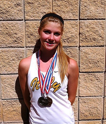 Image: Halee Turner shows off her regional medals as a State qualifying member of Italy High School’s 2013 1A track team.