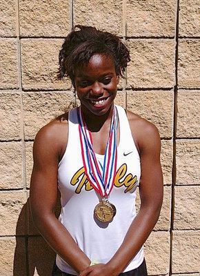 Image: Kortnei Johnson, a junior, displays both her State gold medals earned from competing in the 100 Meter Dash and the 200 Meter Dash as State qualifying member of Italy High School’s 2013 1A track team. Johnson set new state records in both events.
