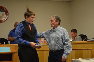 Image: Brett Kirton receives scholarship from Jack Bingham with DCI Sanitation.
