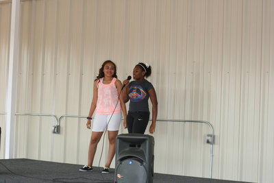 Image: 8th graders, Moisha Wlaker and Vanessa Cantu, sing When I Was Your Man.