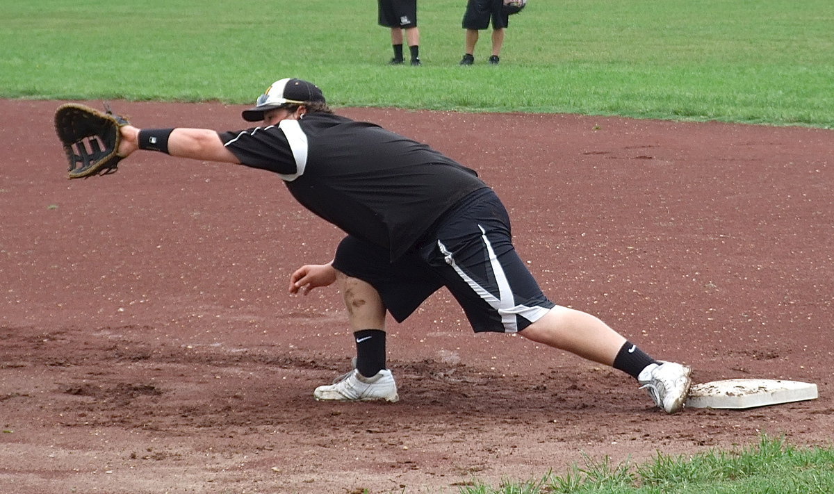 Image: John Byers stretching out at first base.