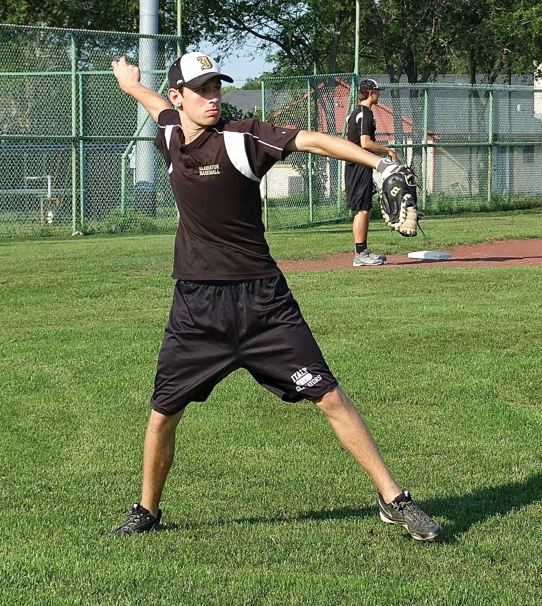 Image: Catcher Ryan Connor throws to first base.