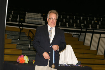 Image: Mr. Bassett honored each student with an academic medal.