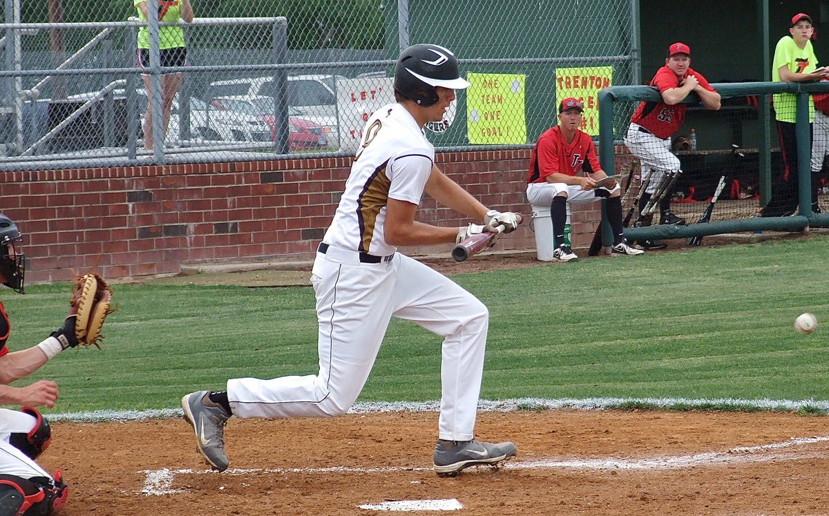 Image: Cole Hopkins(9) bunts his way to first base when Trenton’s pitcher slides in the grass and is unable to make a play on the ball.