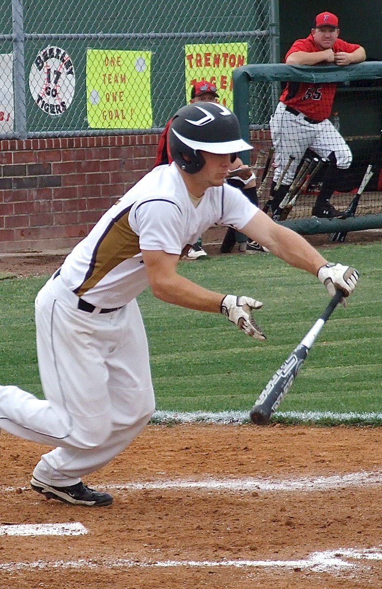 Image: Senior Chase Hamilton(10) bunts his way onto the first base bag.