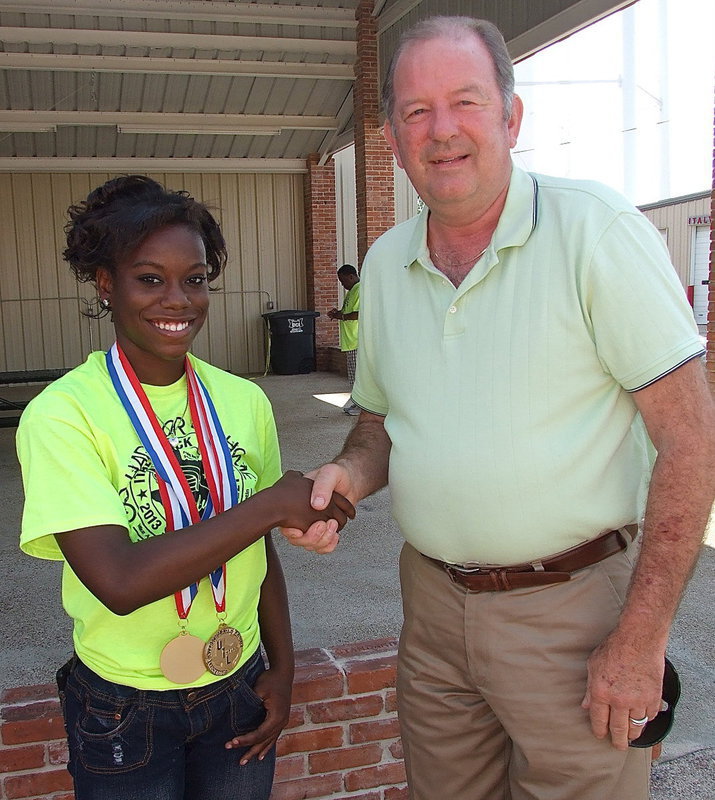 Image: Italy track star, Kortnei Johnson, who recently won two gold medals while breaking two 1A State records in Austin as a sophomore, is congratulated by Mayor of Italy, James Hobbs, during a parade held in mid May to honor Johnson and her state qualifying track mates Halee Turner, Ryisha Copeland and Kendra Copeland, and the Lady Gladiator Softball team and the Gladiator Baseball team.