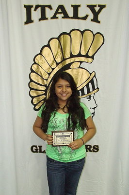 Image: 7th grader Noeli Garcia receives a plaque for perfect attendance.