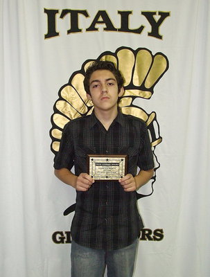 Image: 8th grader Anton Eli Berkley receives a plaque for having no tardies.