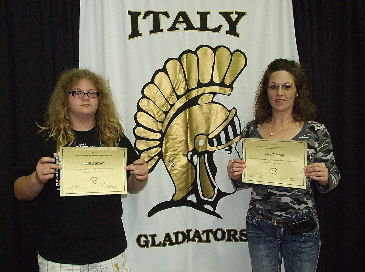 Image: Tomi Newman displays her awards with help from her mother, Laura Tuck.