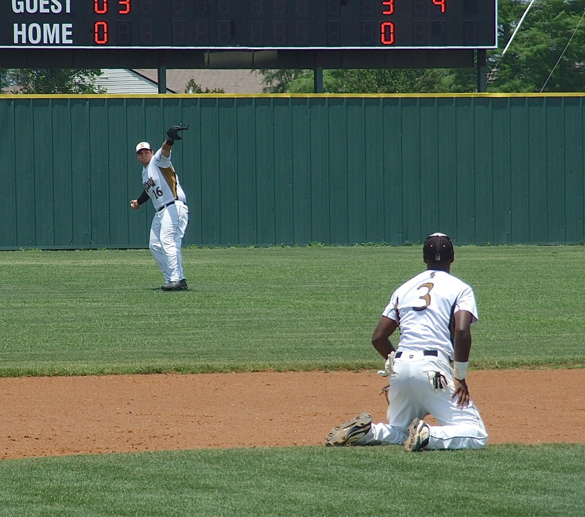 Image: Left fielder, Kevin Roldan(16) relays the throw in after the ball slips past a diving Marvin Cox(3) at third base.