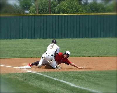 Image: Third baseman, Marvin Cox(3) makes the tag to get a sliding Trenton base runner out.