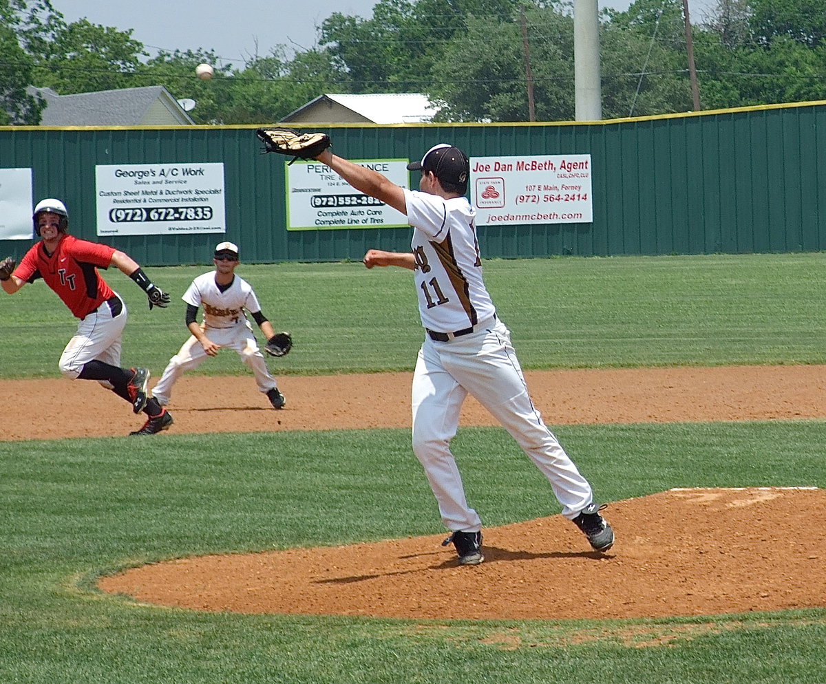 Image: A blooper rises over the mitt of pitcher, Tyler Anderson(11), but no worries as, shortstop, Caden Jacinto(2) is on the spot to make the catch for an out.