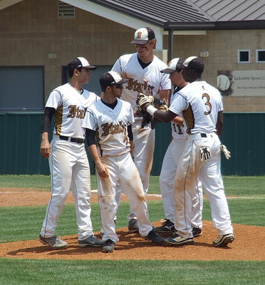 Image: Infielders Reid Jacinto(5), Caden Jacinto(2), Cole Hopkins(9) and Marvin Cox(3) support pitcher Tyler Anderson(11) in a quick get together at the mound.
