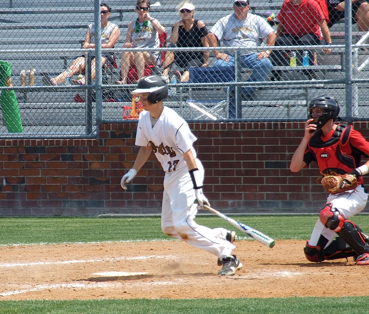 Image: Freshman, Ryan Connor(17) hits and then runs to first base.