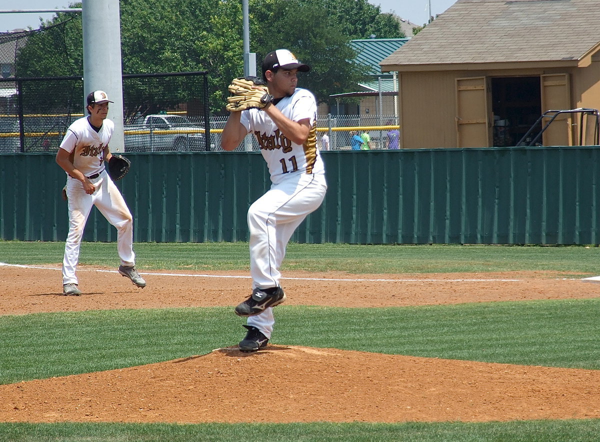 Image: As the game progresses, Tyler Anderson(11) keeps working from the mound as Cole Hopkins(9) plays the gap.